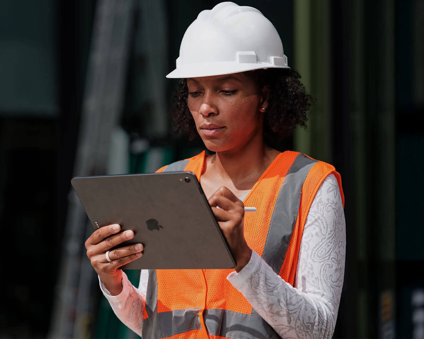 Construction worker holding a mobile device in the field
