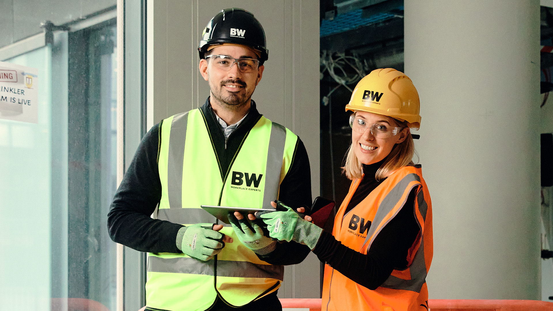 Contractors smiling to the camera, wearing safety equipment