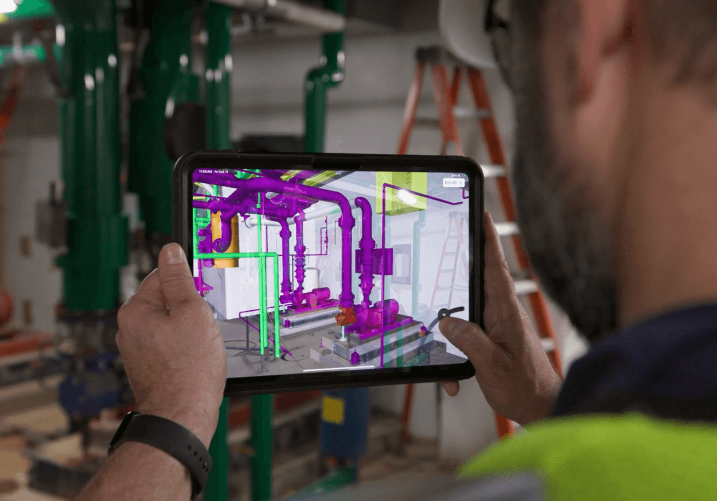 A contractor using BIM on a tablet at a construction site